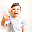 Little Boy Holding Grin Toothpaste & Toothbrush